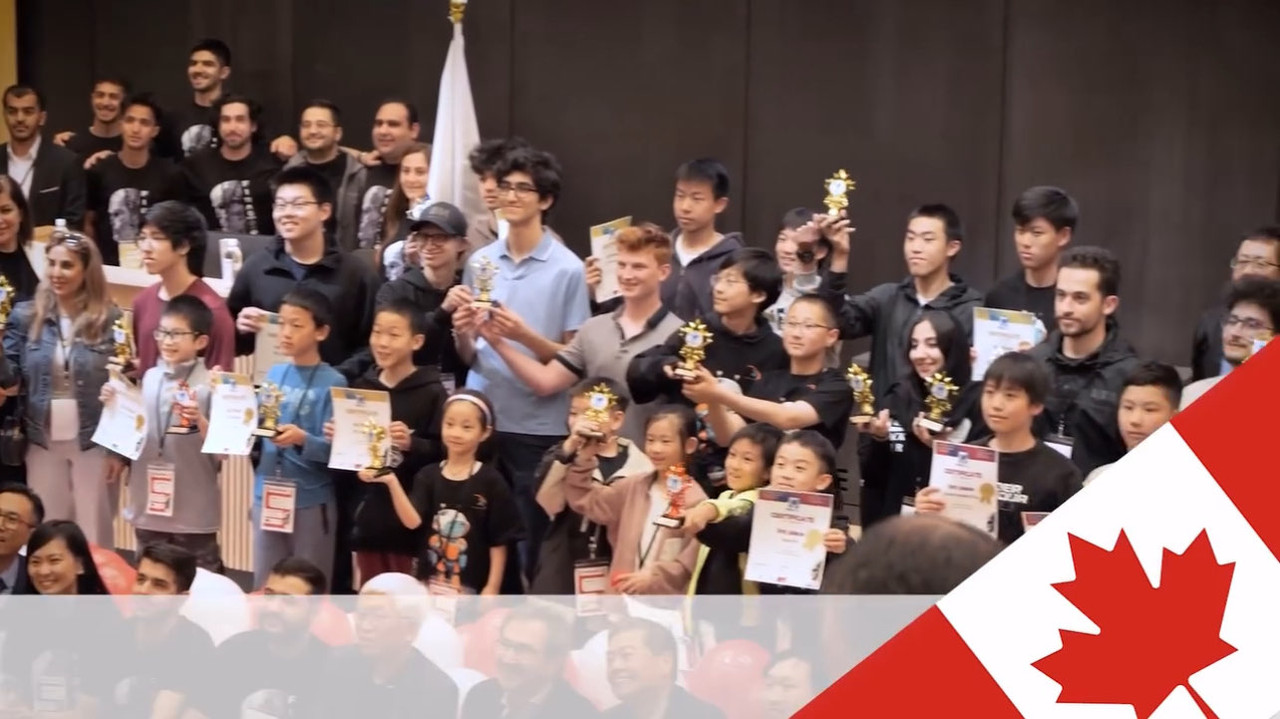 Robotics awards ceremony (Canada) for 2nd placement at sfu — crowd shot of kids holding trophies and certificates with a Canada banner.