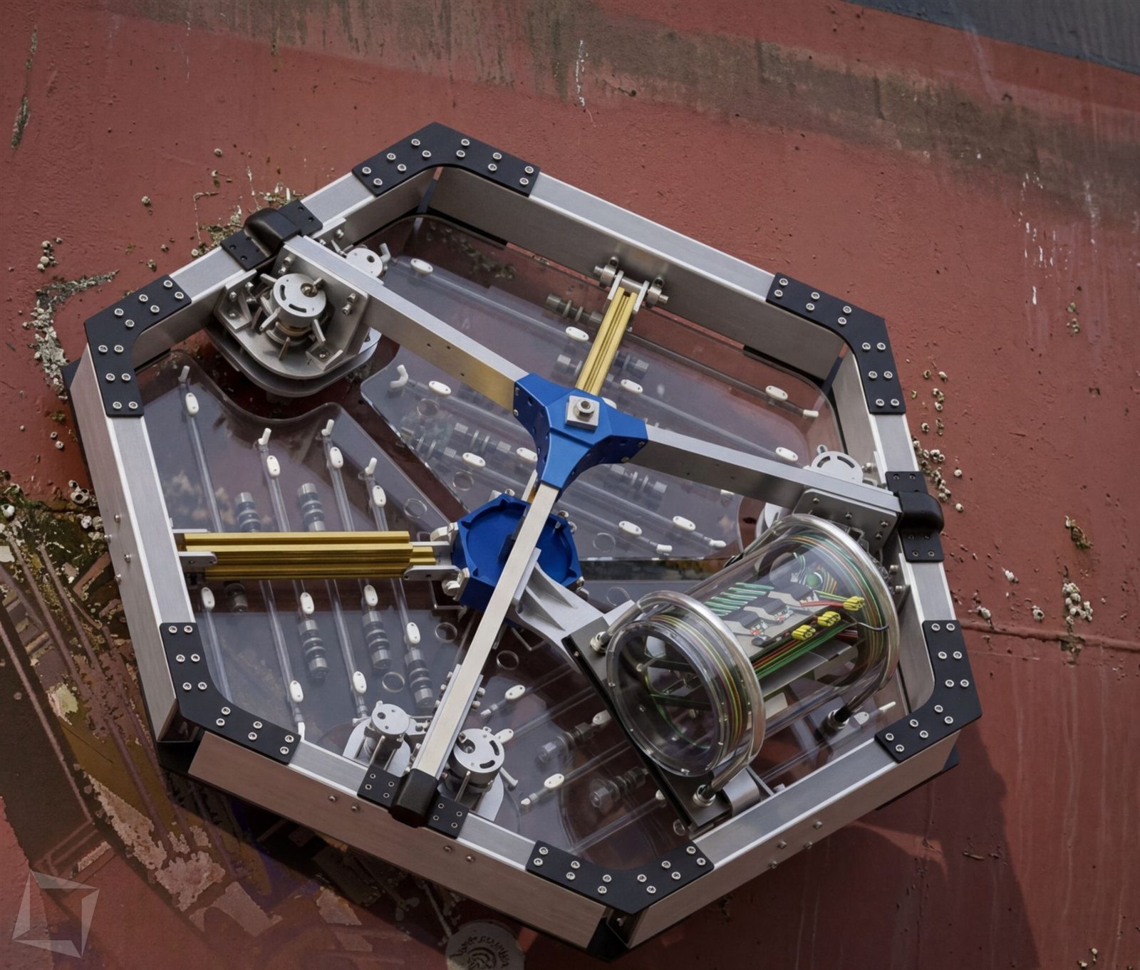 ZIMA on a ship's hull — the rover's layout and treatment architecture, showing the independently steered drive modules it uses to hold position on curved steel.